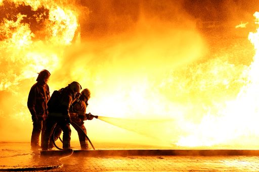 Firefighters extinguishing a large flame