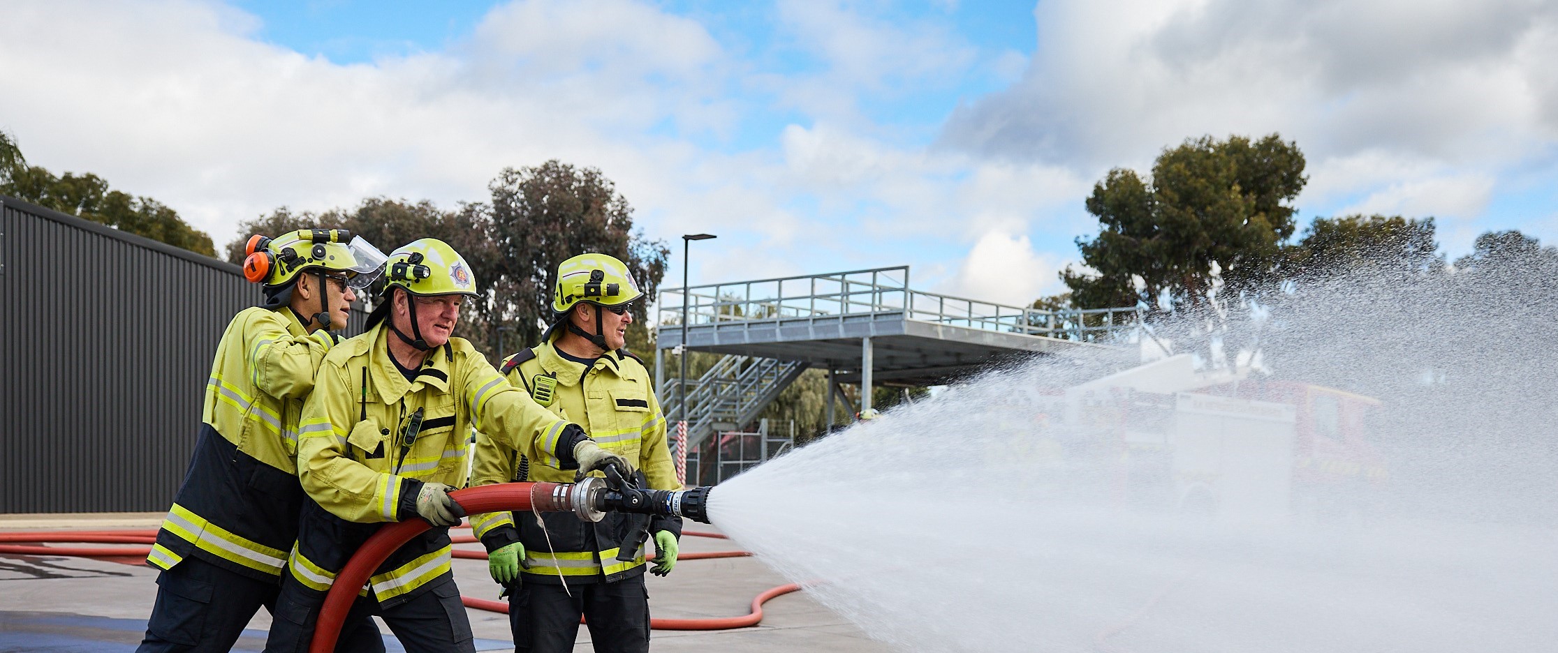 Firefighters with water hose