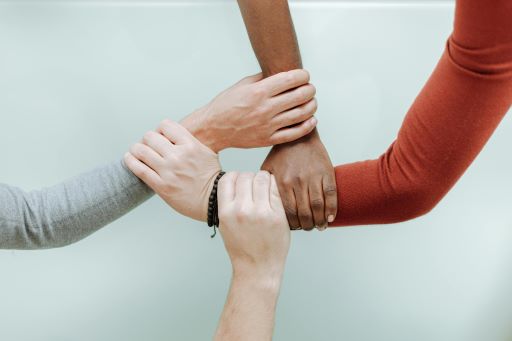 Four hands connecting together