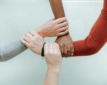 Four hands connecting together