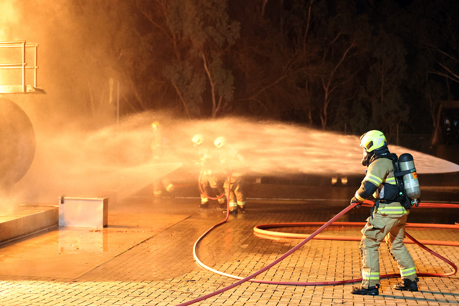 Firefighter recruits during a fire hose drill